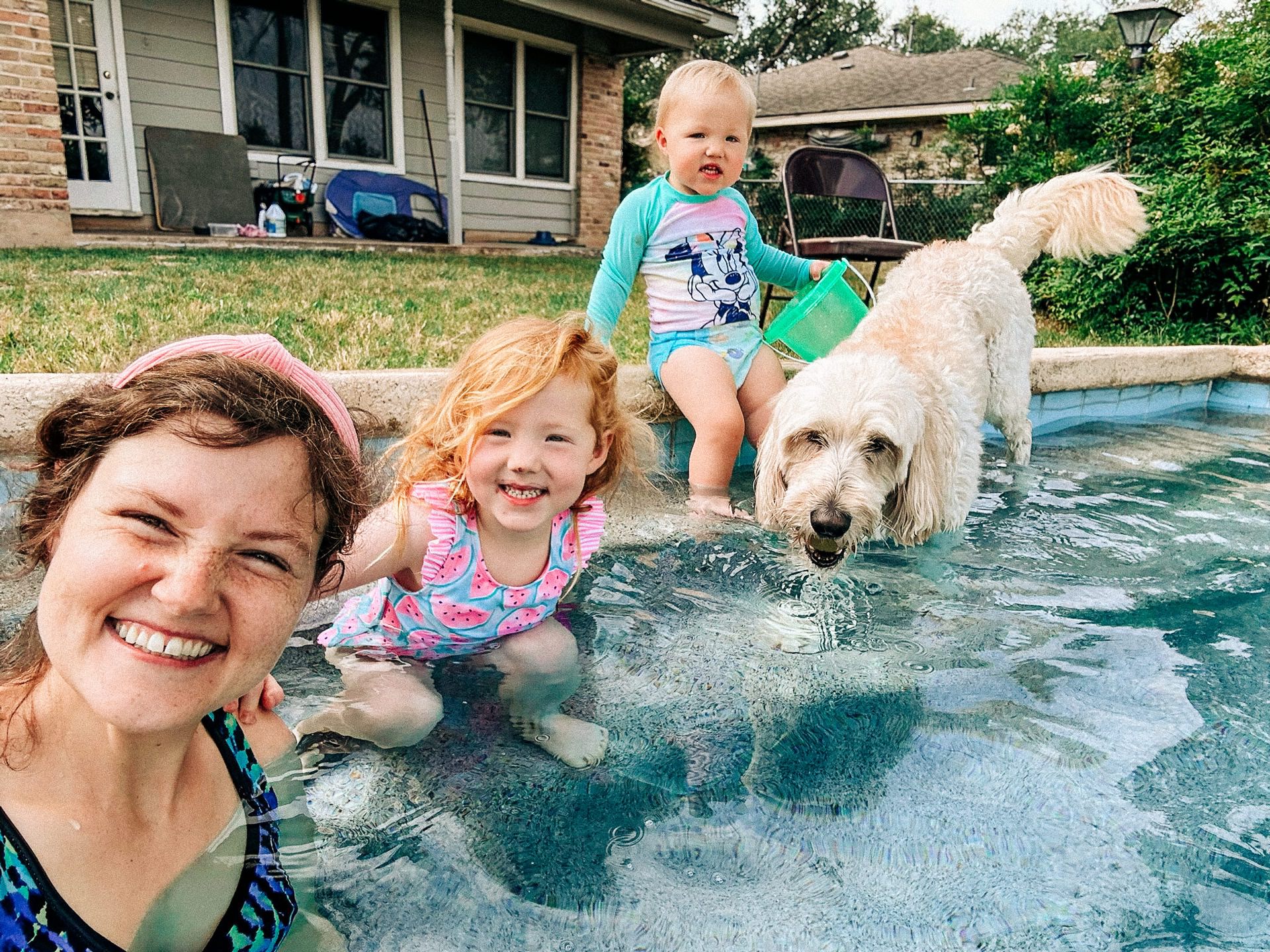 photo of Ellie with Emmie and Ellie and Maggie in Grandpa Sonny's pool
